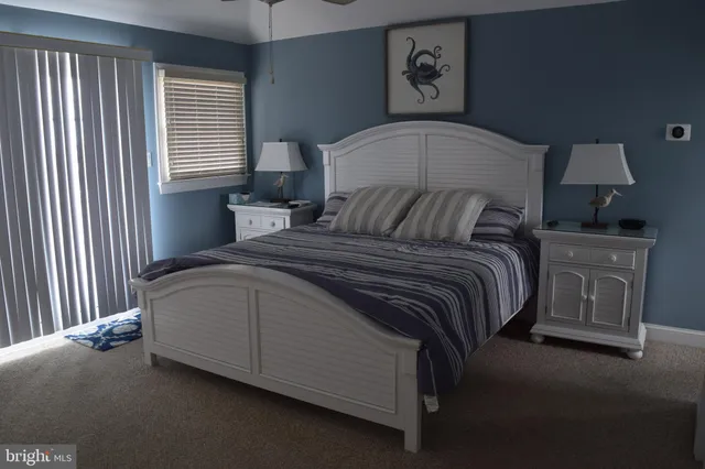 a bedroom with a bed and flat screen tv
