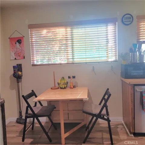 a view of a dining room with furniture and a window