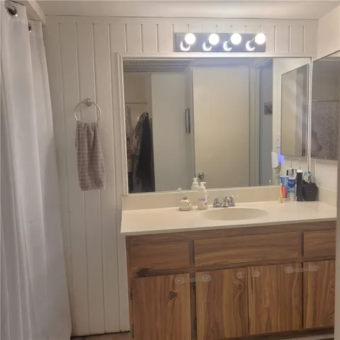 a bathroom with a sink vanity and a mirror