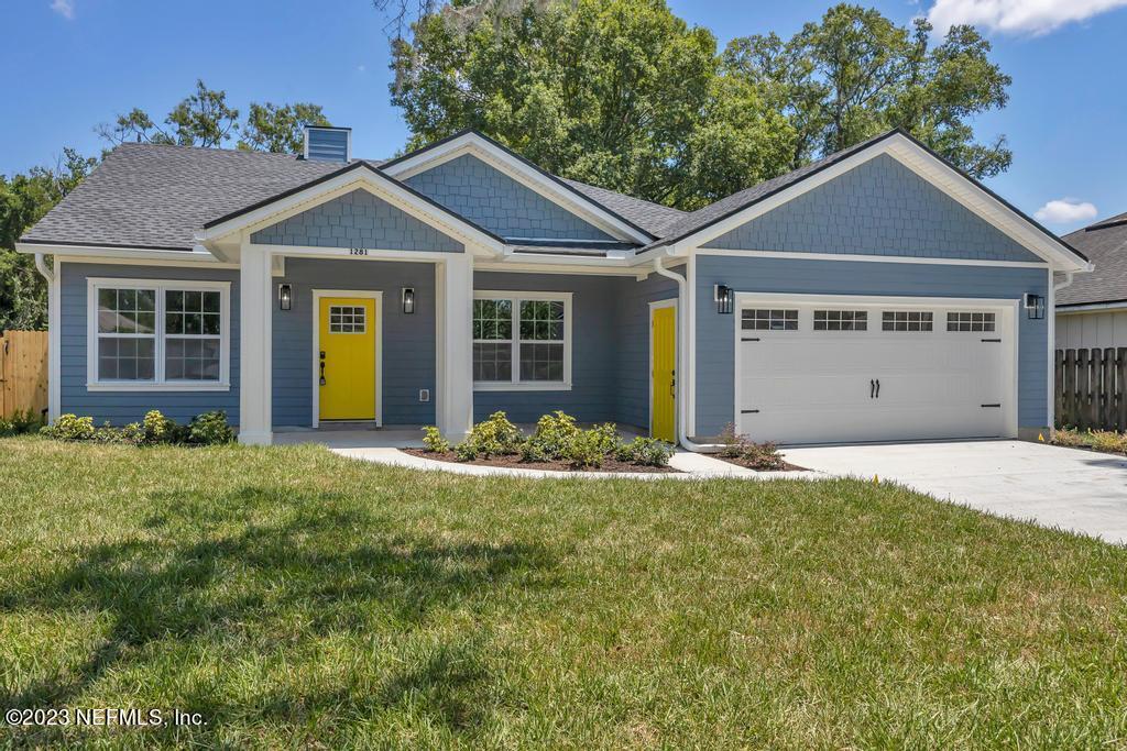a front view of a house with a garden and yard