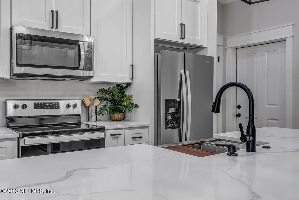 1281 Glen Laura Road Jacksonville, FL 32205 - Photo 11 of 33 a kitchen with stainless steel appliances and a stove top oven