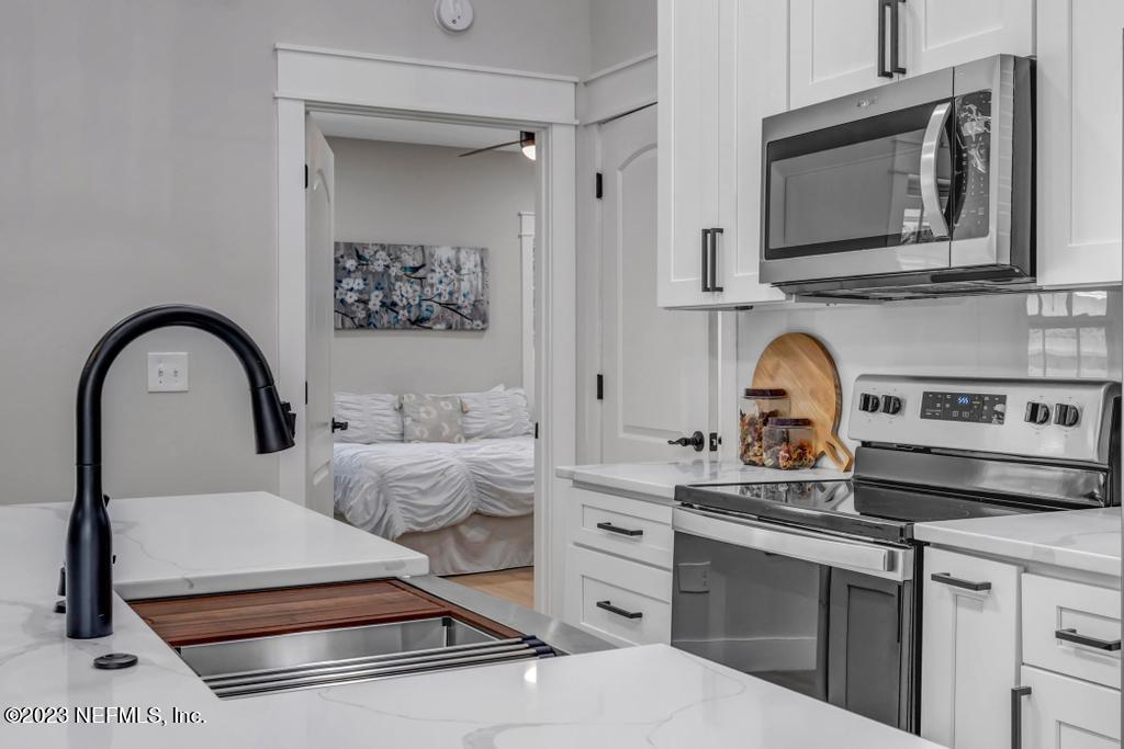 1281 Glen Laura Road Jacksonville, FL 32205 - Photo 12 of 33 a kitchen with stainless steel appliances a stove and cabinets
