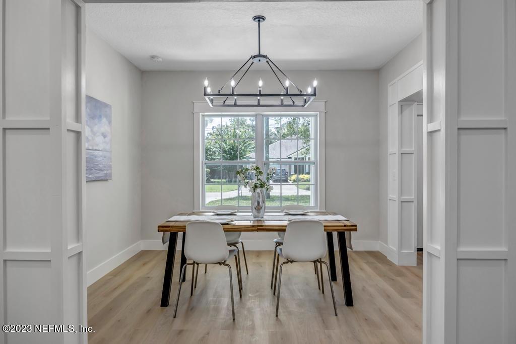 1281 Glen Laura Road Jacksonville, FL 32205 - Photo 13 of 33 a view of a dining room with furniture window and wooden floor