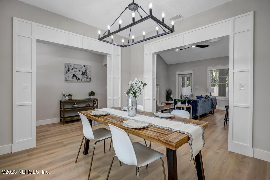 1281 Glen Laura Road Jacksonville, FL 32205 - Photo 14 of 33 a view of a dining room with furniture and wooden floor