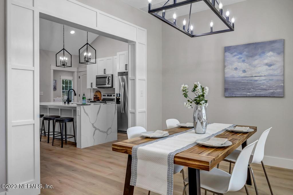 1281 Glen Laura Road Jacksonville, FL 32205 - Photo 15 of 33 a view of a dining room with furniture and wooden floor