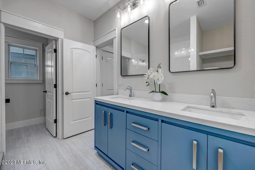 1281 Glen Laura Road Jacksonville, FL 32205 - Photo 21 of 33 a bathroom with a double vanity sink and mirror