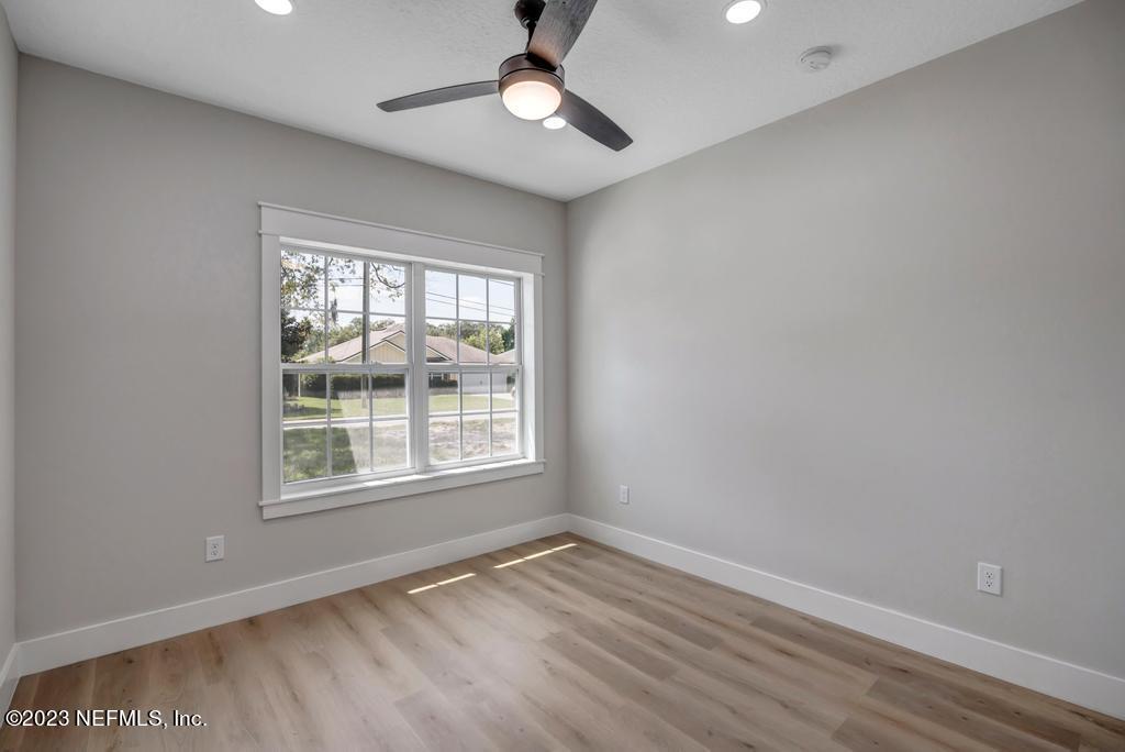 1281 Glen Laura Road Jacksonville, FL 32205 - Photo 24 of 33 wooden floor in an empty room with a window