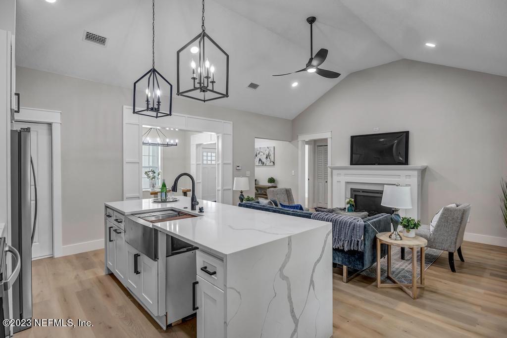 1281 Glen Laura Road Jacksonville, FL 32205 - Photo 10 of 33 a kitchen with a sink a stove and chairs