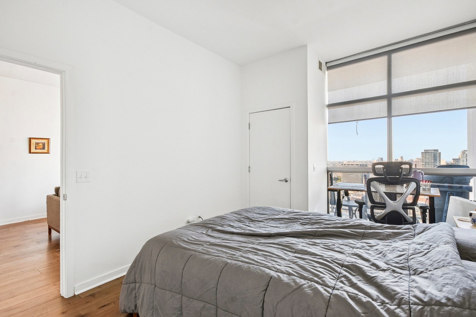 303 West Ohio Street, Unit 3309 Chicago, IL 60654 - Photo 13 of 23 a bedroom with a bed and a large window