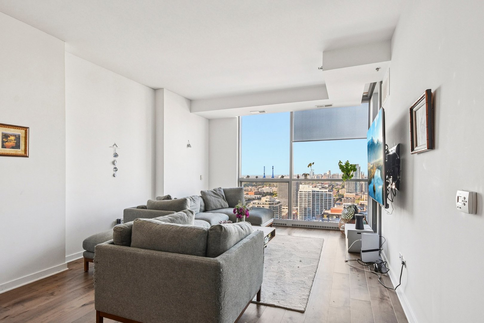 303 West Ohio Street, Unit 3309 Chicago, IL 60654 - Photo 3 of 23 a living room with furniture and a view of kitchen