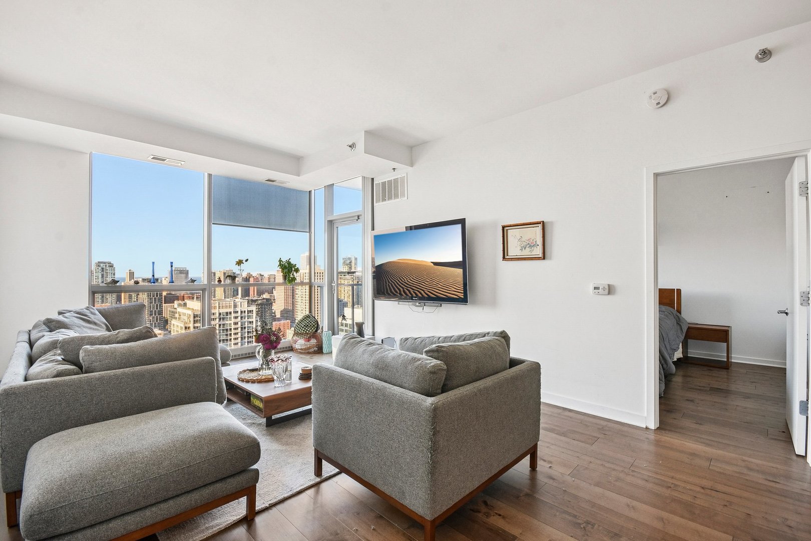 303 West Ohio Street, Unit 3309 Chicago, IL 60654 - Photo 6 of 23 a living room with furniture and a wooden floor