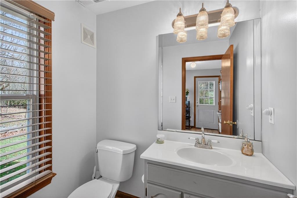 221 Hartzell School Road Fombell, PA 16123 - Photo 11 of 40 a bathroom with a toilet a sink and mirror