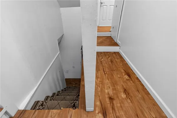 a view of stairs and wooden floor