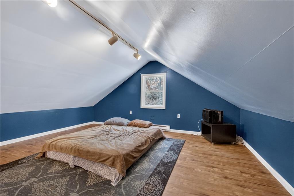 221 Hartzell School Road Fombell, PA 16123 - Photo 20 of 40 a bedroom with a bed and a chandelier