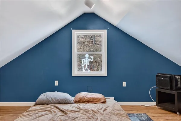 a bedroom with a bed and a window