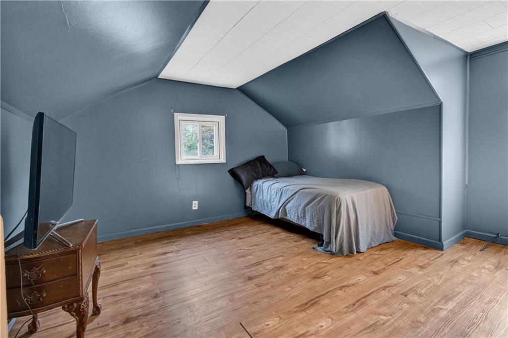 221 Hartzell School Road Fombell, PA 16123 - Photo 24 of 40 a bedroom with a bed and a flat screen tv