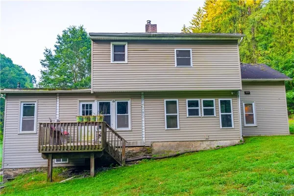 a front view of a house with a deck