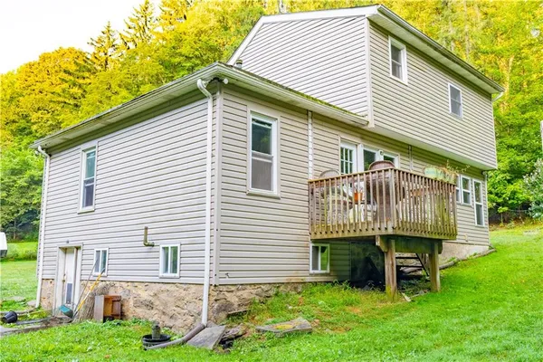 a front view of a house with a garden and deck