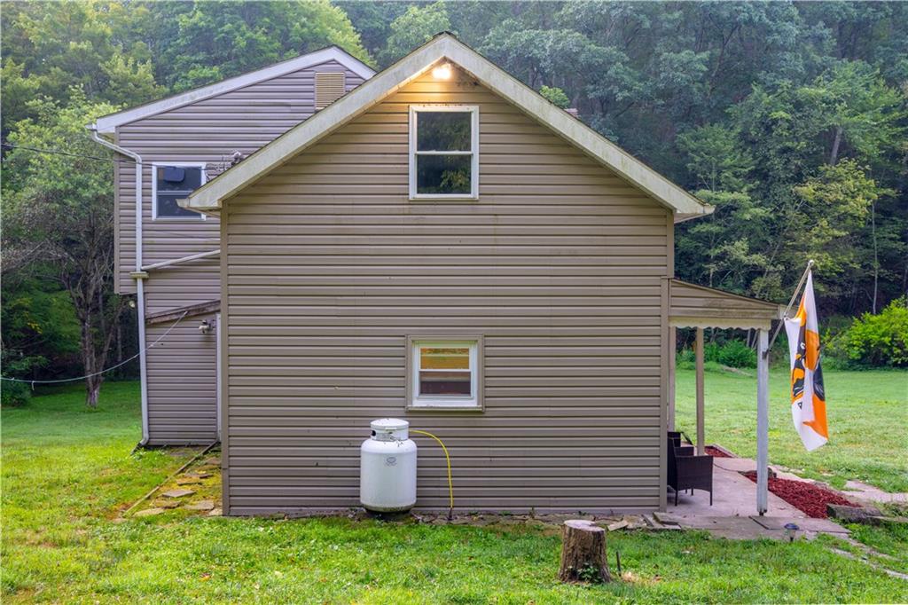 221 Hartzell School Road Fombell, PA 16123 - Photo 32 of 40 a backyard of a house with seating space