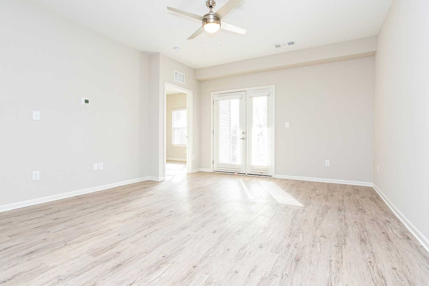1253 McCawley Road Other, KY 40219 - Photo 11 of 13 an empty room with wooden floor fan and windows