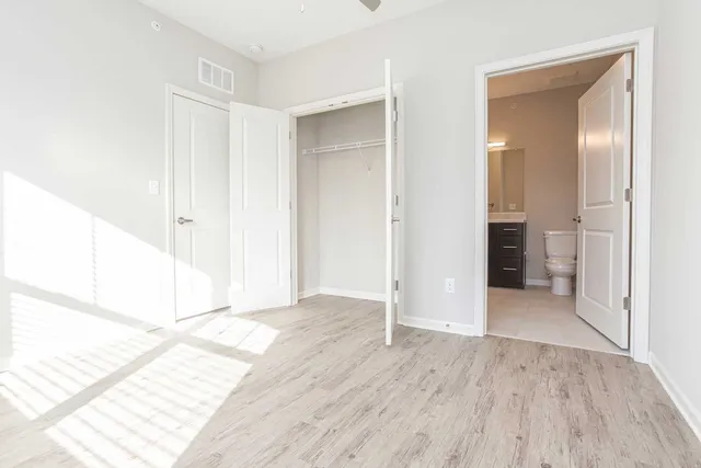 a view of an empty room with wooden floor