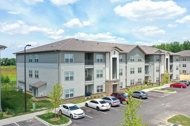 a front view of a house with a garden and patio