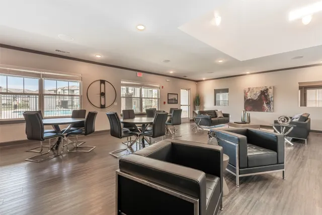a living room with furniture a rug and a window