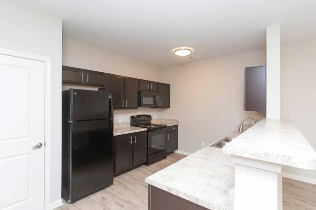 a kitchen with a refrigerator and a sink