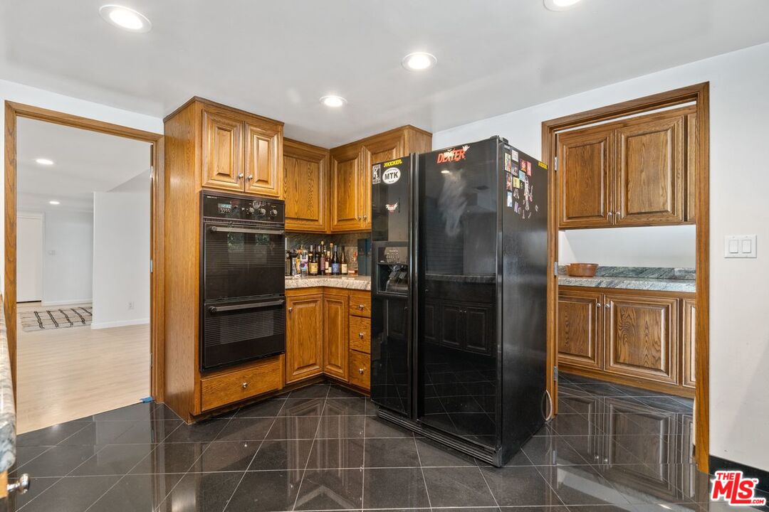 3135 Chandelle Road Los Angeles, CA 90046 - Photo 12 of 29 a kitchen with stainless steel appliances granite countertop a refrigerator and a sink