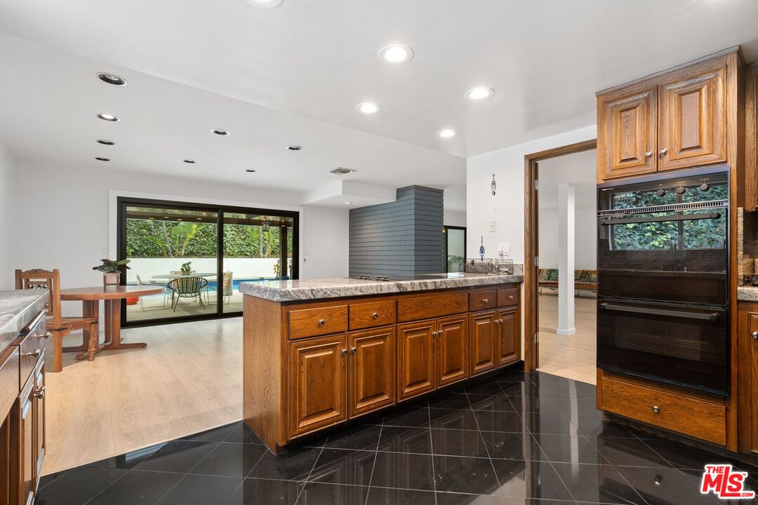 3135 Chandelle Road Los Angeles, CA 90046 - Photo 13 of 29 a large kitchen with kitchen island granite countertop a large window and a counter space
