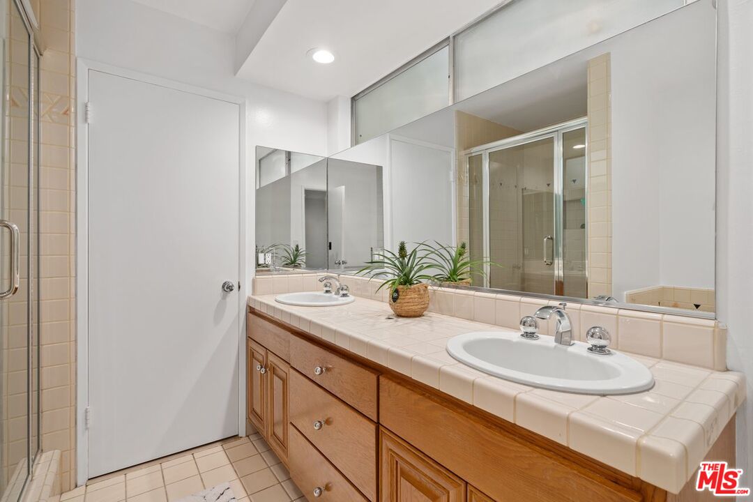 3135 Chandelle Road Los Angeles, CA 90046 - Photo 16 of 29 a bathroom with a sink and a mirror