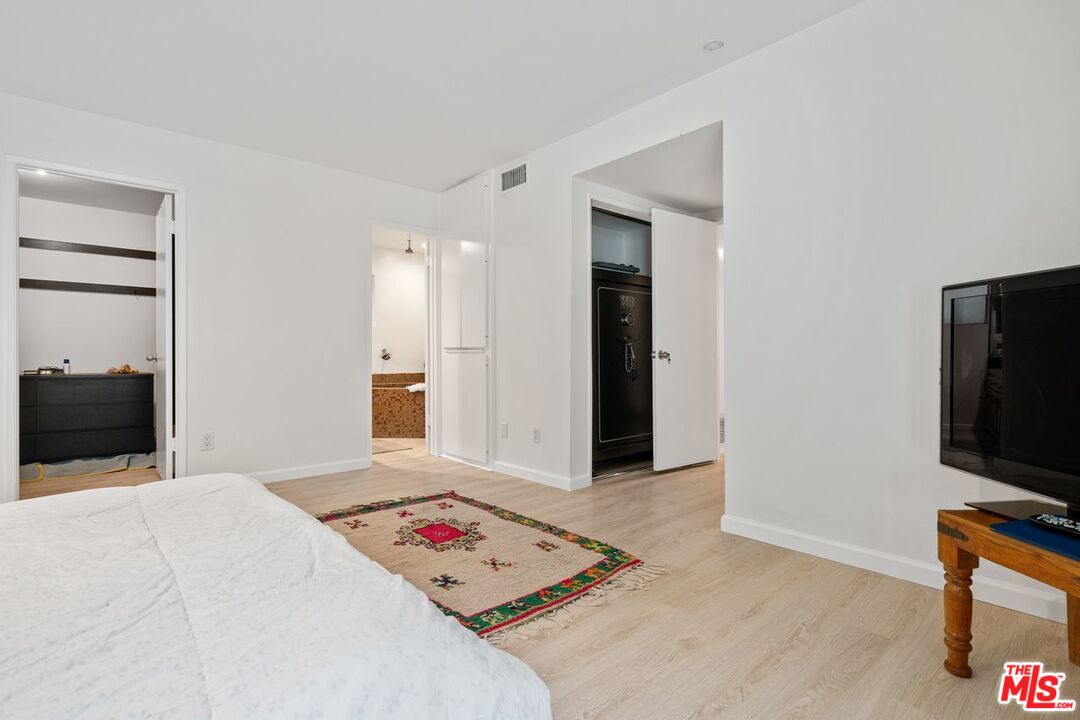 3135 Chandelle Road Los Angeles, CA 90046 - Photo 21 of 29 a bedroom with a bed and a flat screen tv