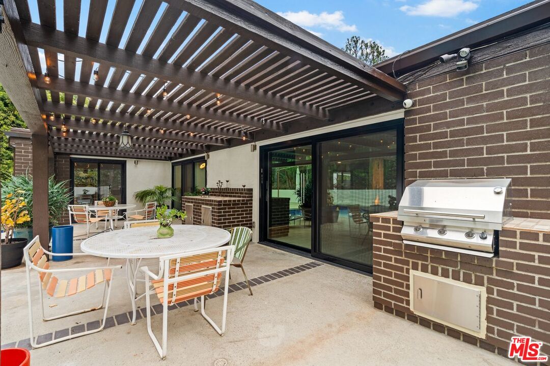 3135 Chandelle Road Los Angeles, CA 90046 - Photo 23 of 29 a patio with a table and chairs and potted plants