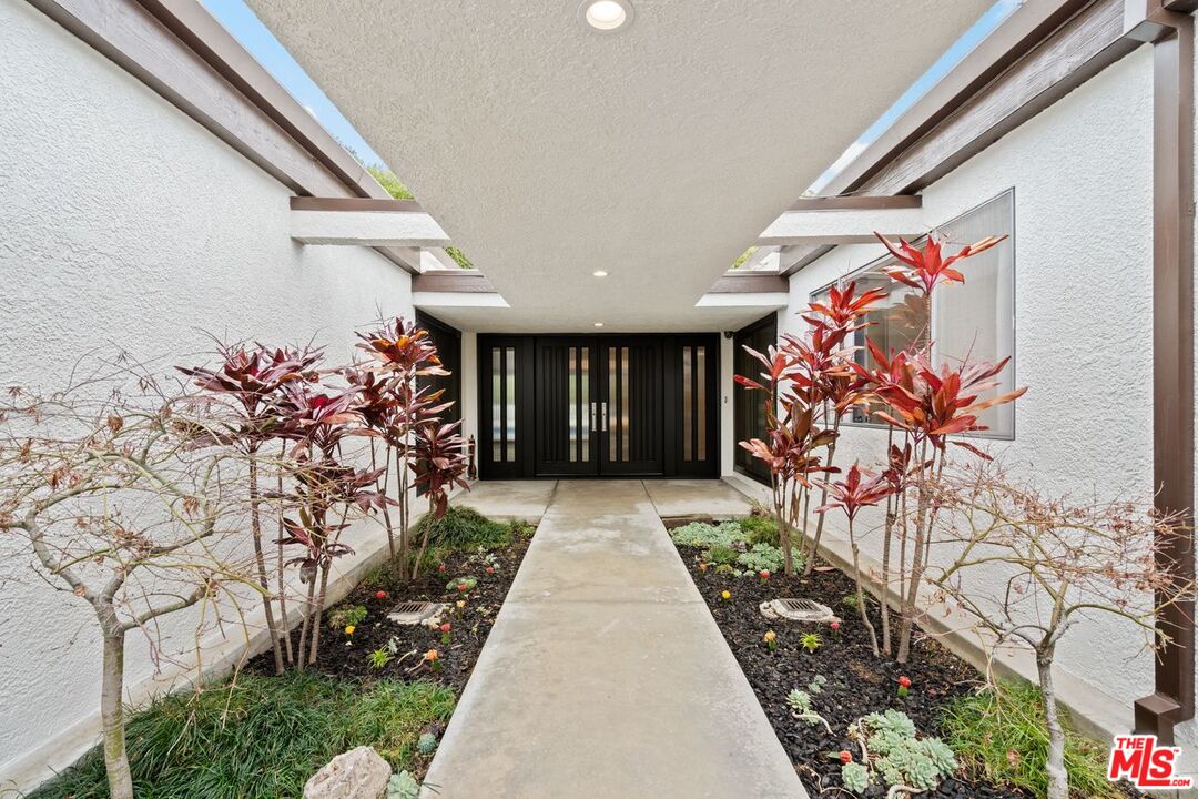 3135 Chandelle Road Los Angeles, CA 90046 - Photo 3 of 29 a front view of a house with flowers