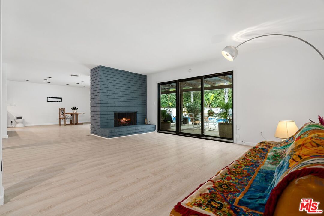 3135 Chandelle Road Los Angeles, CA 90046 - Photo 6 of 29 a bed room with a bed and a fireplace