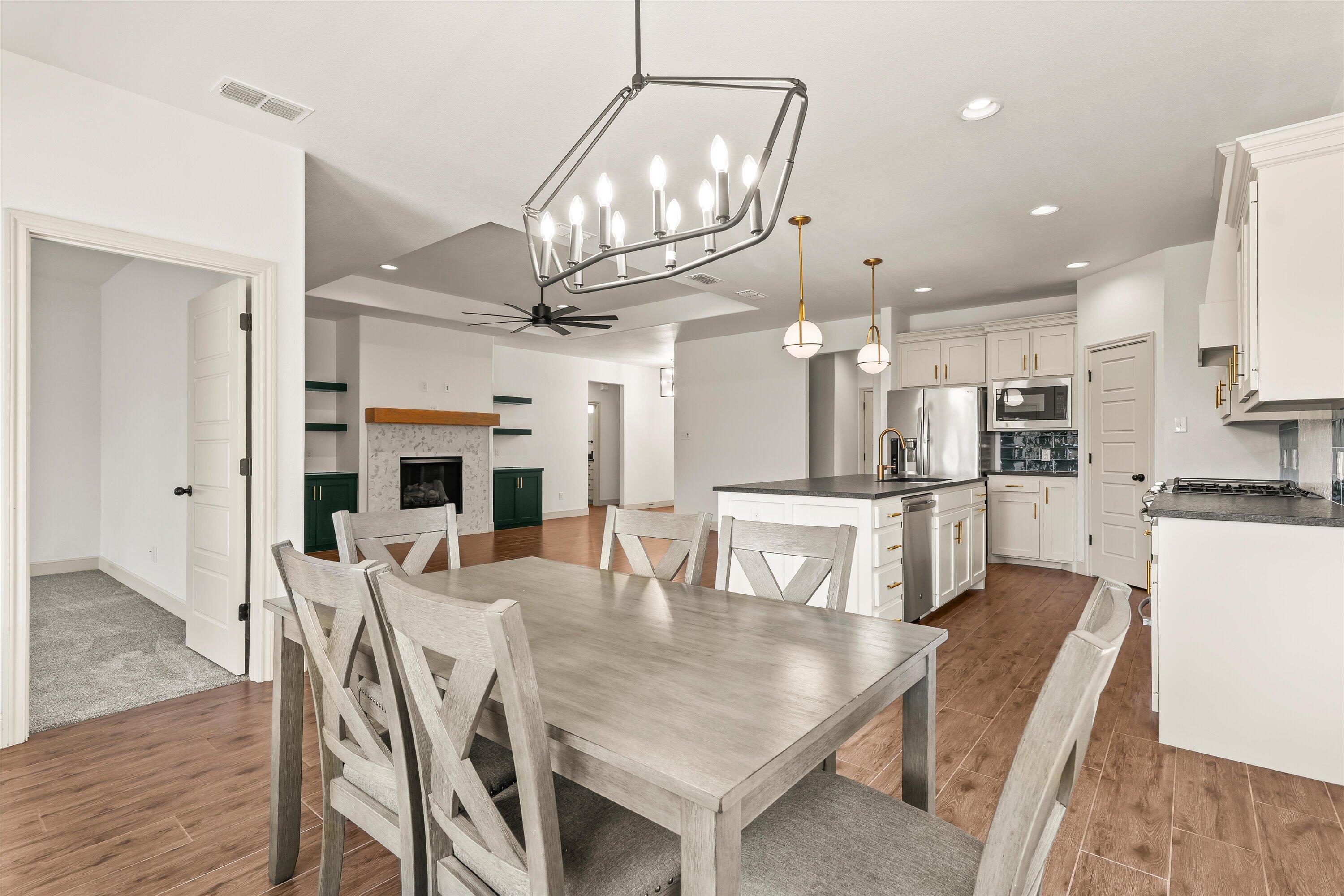 5719 116th Street Lubbock, TX 79424 - Photo 11 of 31 a view of a dining room with furniture and a chandelier