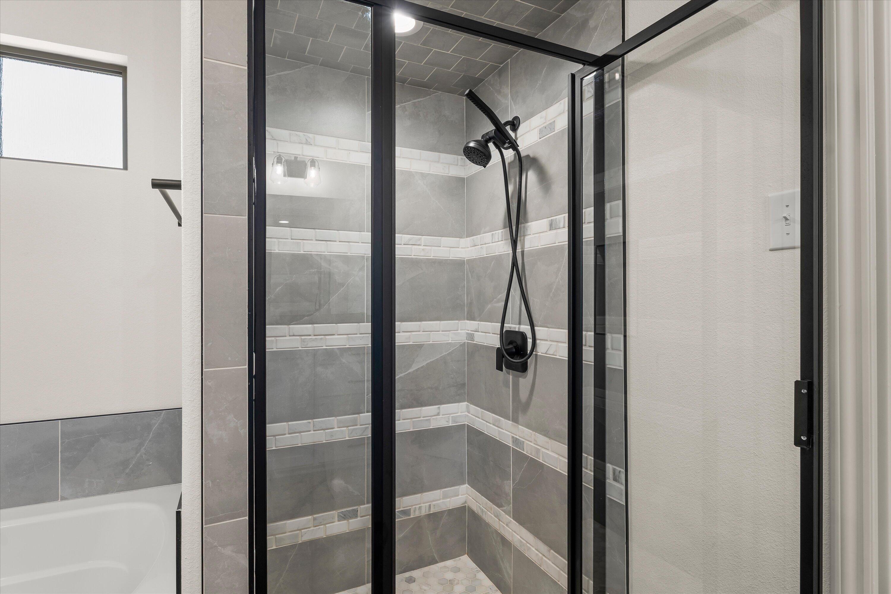 5719 116th Street Lubbock, TX 79424 - Photo 17 of 31 a bathroom with a glass shower door