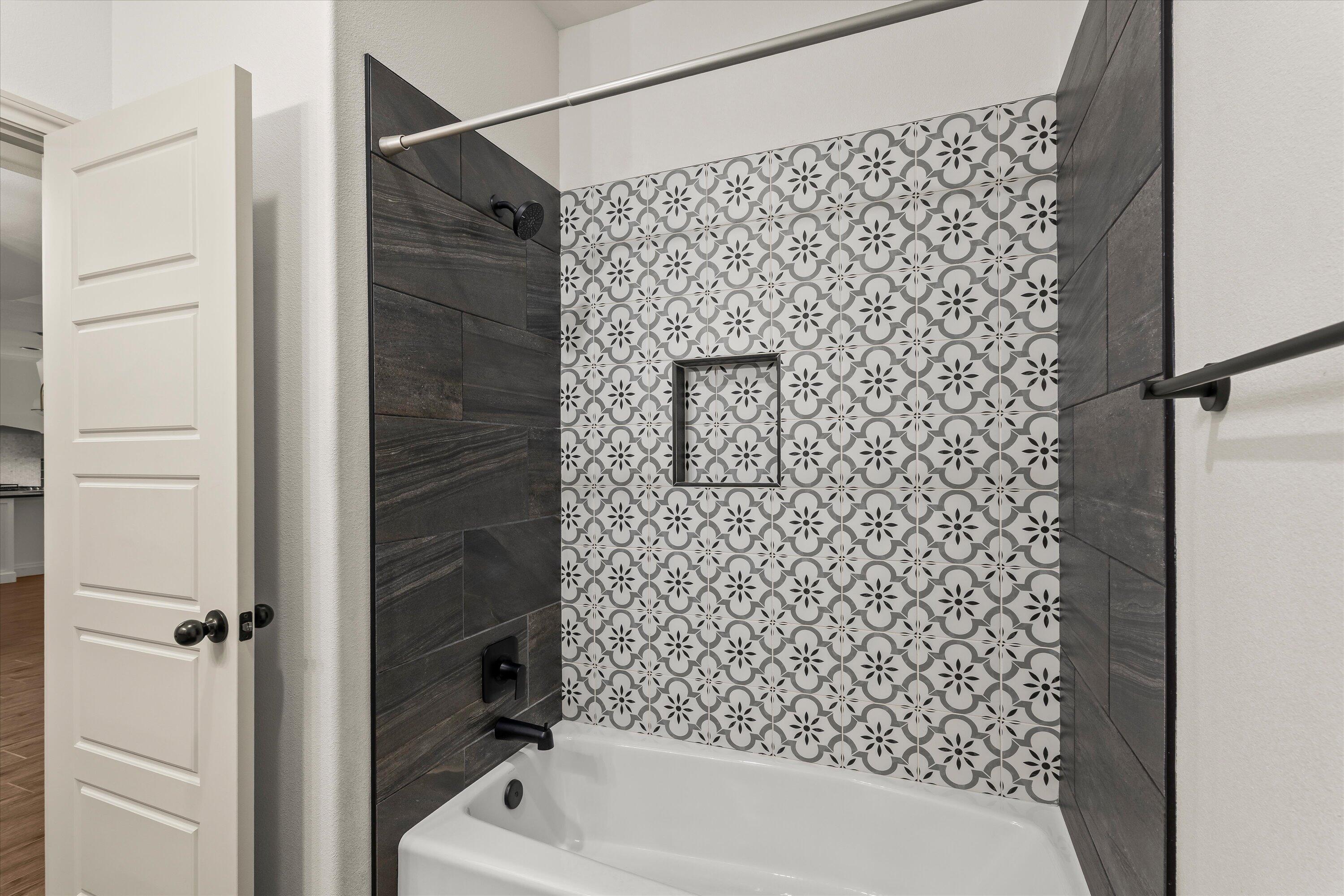 5719 116th Street Lubbock, TX 79424 - Photo 22 of 31 a bathroom with a bathtub and shower