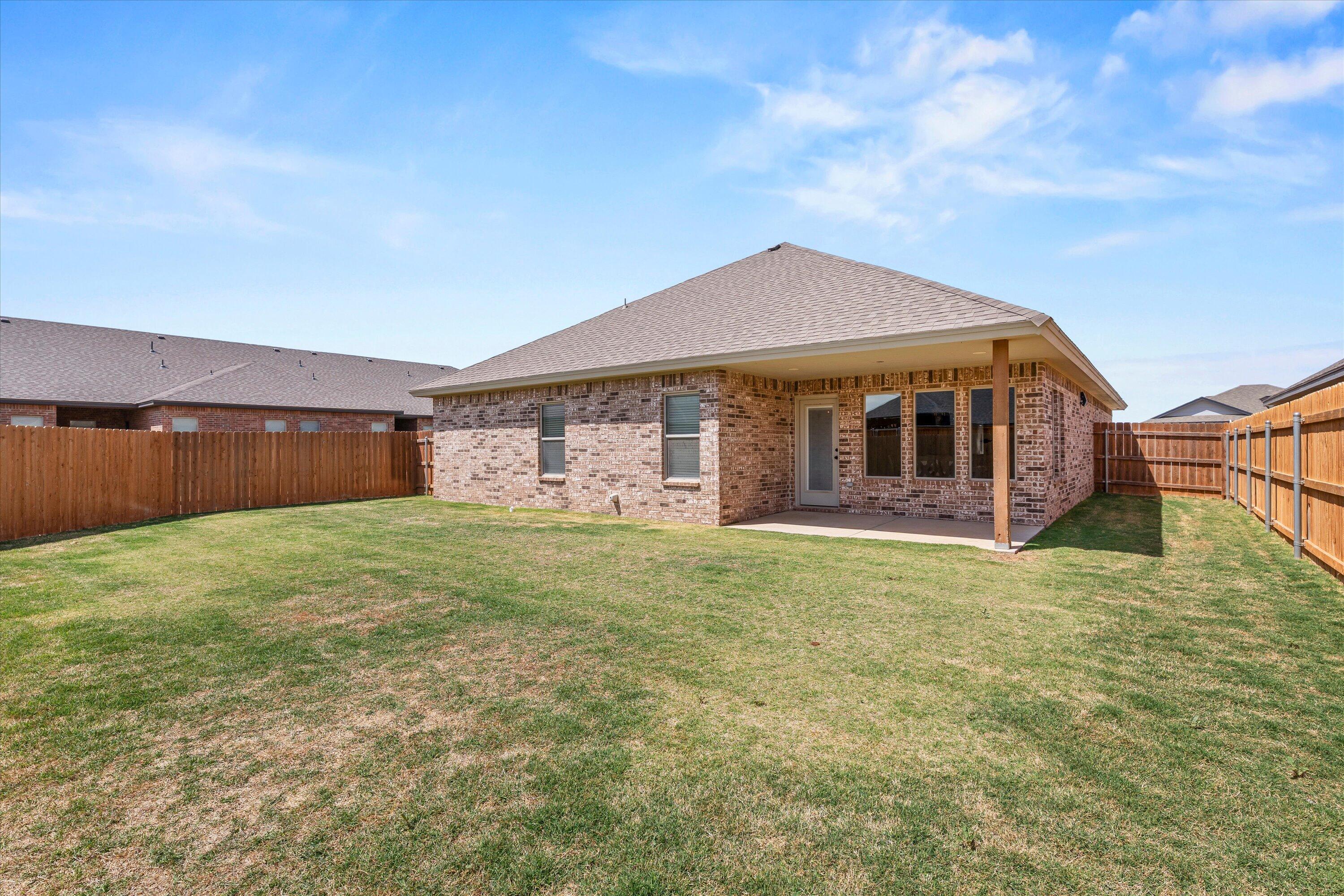 5719 116th Street Lubbock, TX 79424 - Photo 29 of 31 a view of a house with a backyard