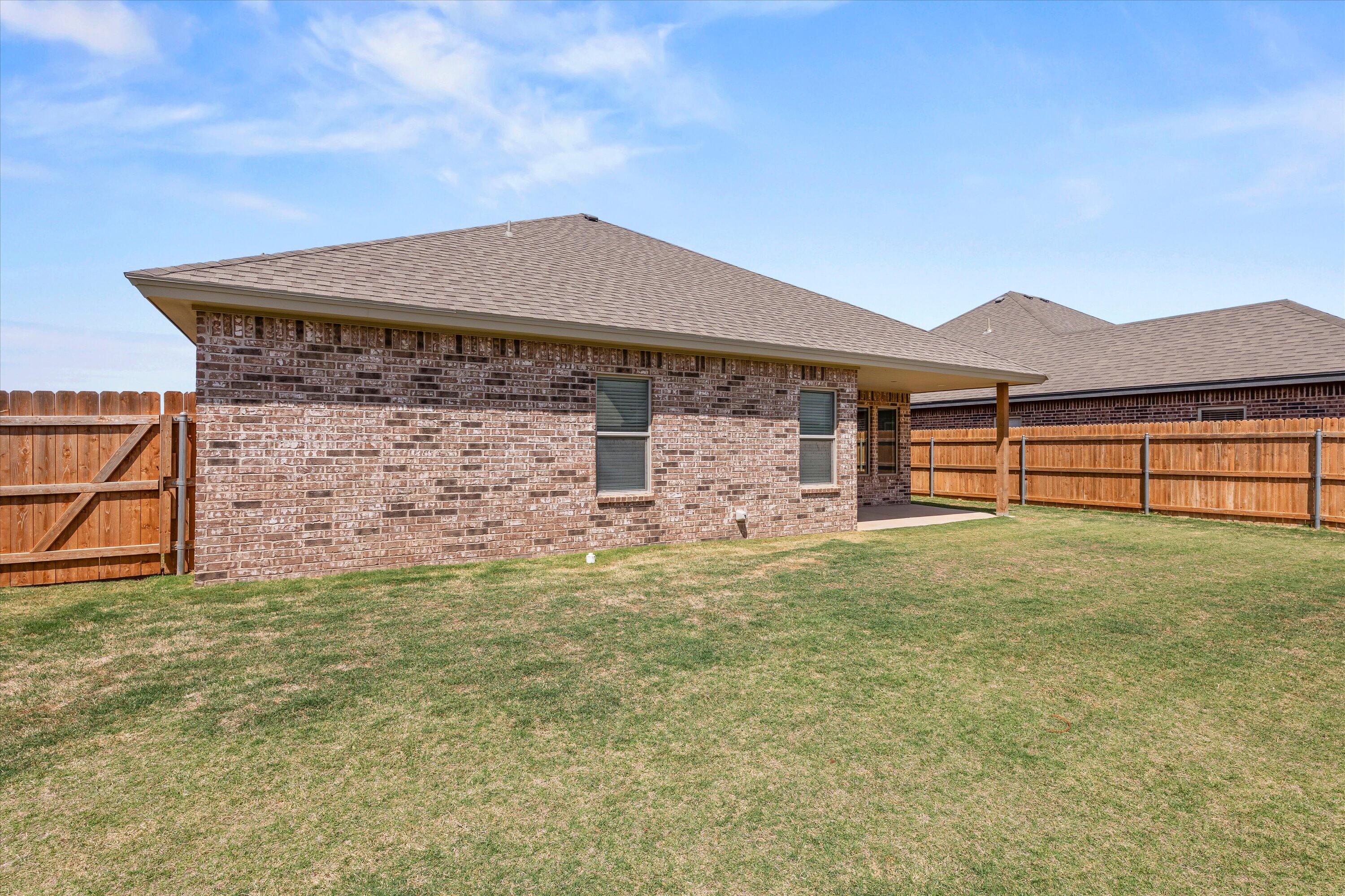 5719 116th Street Lubbock, TX 79424 - Photo 30 of 31 a backyard of a house with lots of green space