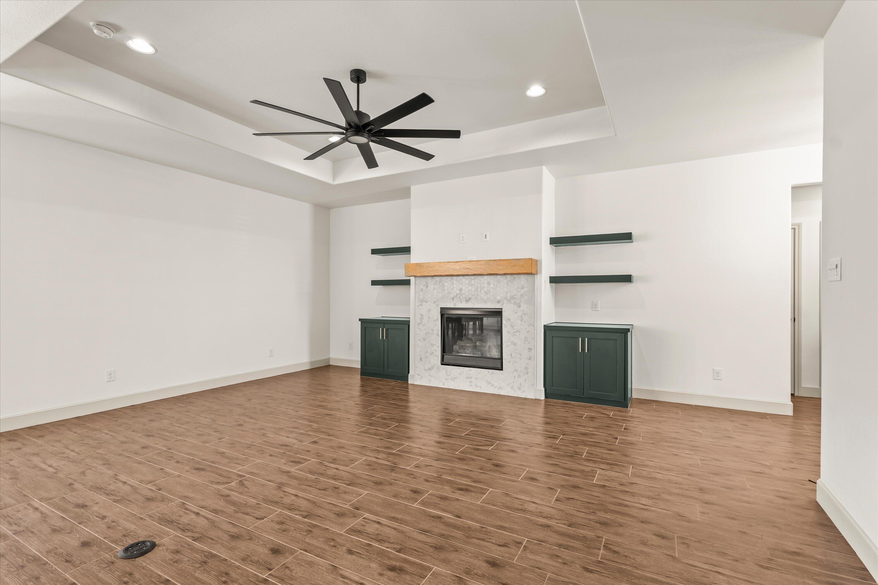 5719 116th Street Lubbock, TX 79424 - Photo 7 of 31 a view of an empty room with a fireplace and a window