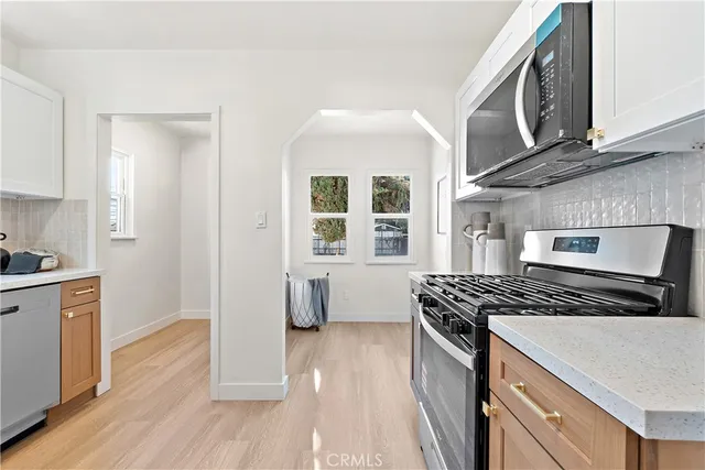 a kitchen with granite countertop a stove and a sink