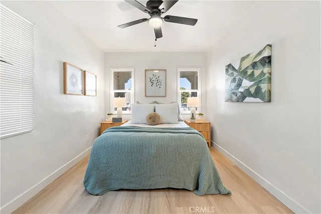 a bedroom with a bed and a painting on the wall