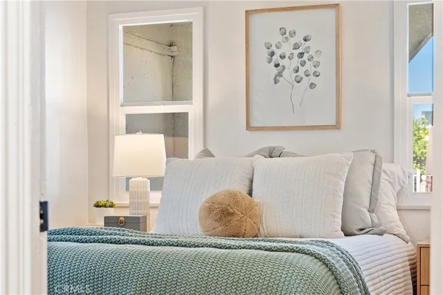 a view of a hallway with wooden floor and a bathroom