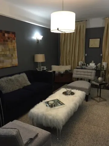 a living room with furniture and a lamp