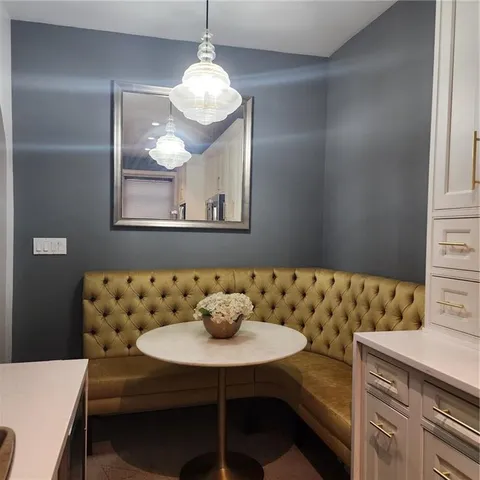 a view of a dining room with furniture and chandelier