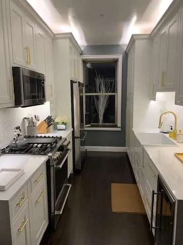 a kitchen with a stove oven and sink