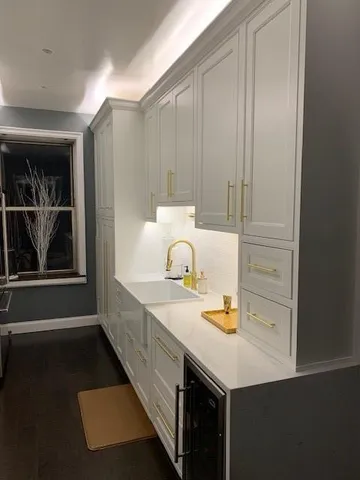 a kitchen with a sink and cabinets
