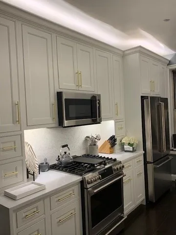 a kitchen with stainless steel appliances a sink a stove and microwave