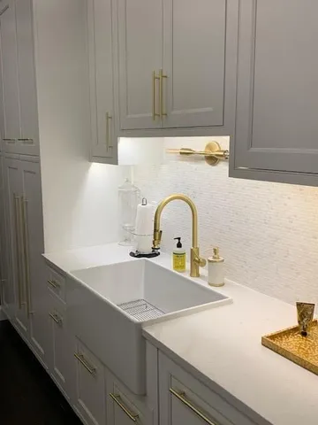 a kitchen with a sink and cabinets